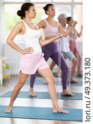 Fit woman exercising with figure eight resistance tube in fitness studio. Стоковое фото, фотограф Яков Филимонов / Фотобанк Лори