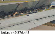 Airplane wing spoilers extending during landing approach. Стоковое фото, фотограф Mikhail Davidovich / Фотобанк Лори