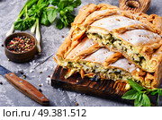 Homemade pie with egg, spinach and onion stuffing. Pie with green and eggs. Стоковое фото, агентство Ingram Publishing / Фотобанк Лори