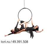 Young women doing gymnastic exercises on the hoop. Стоковое фото, агентство Ingram Publishing / Фотобанк Лори