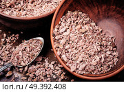 Grinded rhizomes of plant iris in mortar.Herbal medicine.Herbalism. Grinded rhizomes of iris. Стоковое фото, агентство Ingram Publishing / Фотобанк Лори