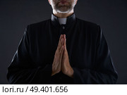 Praying hands priest portrait of male pastor. Стоковое фото, агентство Ingram Publishing / Фотобанк Лори