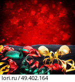 Carnaval festive decorations isolated borer over white background with copy space. Carnaval decorations on dark wooden background. Стоковое фото, агентство Ingram Publishing / Фотобанк Лори