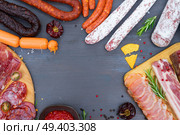 spanish tapas with pancetta, salami, chorizo, lomo, jamon with red hol salsa sause and olives, picnic table, top view frame with copy space. Picnic table with spanish sausage tapas. Стоковое фото, агентство Ingram Publishing / Фотобанк Лори