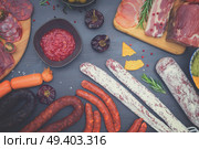 spanish tapas with salami, chorizo, lomo, jamon with red hol salsa sause and olives, picnic table, top view, retro toned. Picnic table with spanish sausage tapas. Стоковое фото, агентство Ingram Publishing / Фотобанк Лори