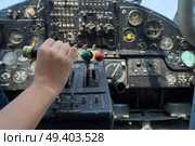 Vintage airplane dashboard with hand pushing leverer, shallow focus on hand. Vintage airplane dashboard. Стоковое фото, агентство Ingram Publishing / Фотобанк Лори
