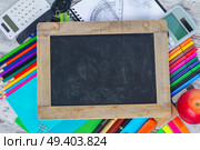 Empty Chalkboard with copy space and school supplies. Chalkboard and school supplies. Стоковое фото, агентство Ingram Publishing / Фотобанк Лори