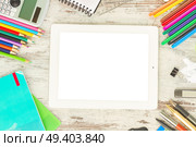 back to school frame with school supplies and tablet with empty screen on wooden table. back to school frame. Стоковое фото, агентство Ingram Publishing / Фотобанк Лори