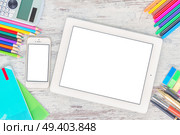 back to school hero header with school supplies on wooden table, copy space on blank screen of tablet and phone. back to school frame. Стоковое фото, агентство Ingram Publishing / Фотобанк Лори
