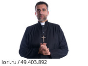 Priest pastor portrait praying hands relaxed. Стоковое фото, агентство Ingram Publishing / Фотобанк Лори