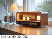 A classic 1970s-style vintage radio with prominent large dials and a traditional design. It’s bathed in warm light and functions as a nostalgic music player.,  created by ai. Стоковое AI-изображение, AI-художник Виталий Сова / Фотобанк Лори