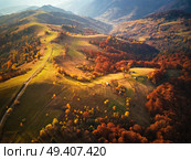 Beautiful mountain autumn landscape with meadow and colorful forest. Red, Yellow, Orange trees on hillsides. National Natural Park Synevyr, Carpathians, Ukraine, Europe. Стоковое фото, агентство Ingram Publishing / Фотобанк Лори