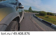 The crossover drives through a roundabout and onto a straight road. Стоковое видео, видеограф Ярославский Максим / Фотобанк Лори
