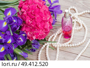 pink hortensia and violet irise  flowers and bottle of fragrance. Стоковое фото, агентство Ingram Publishing / Фотобанк Лори