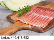 platter of spanish cured  ham jamon close up with melon. Стоковое фото, агентство Ingram Publishing / Фотобанк Лори