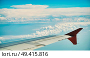Aircraft wing soaring through pristine white clouds against vibrant blue skyline. Стоковое фото, фотограф Mikhail Davidovich / Фотобанк Лори