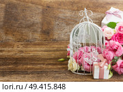 bunch of pink and white fresh roses and eustoma flowers  with present  box on wooden background  with copy space. pink and white flowers. Стоковое фото, агентство Ingram Publishing / Фотобанк Лори