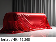 A red car is completely covered by a red cloth, blending seamlessly into its vibrant surroundings. Стоковое AI-изображение, AI-художник Данила Большаков / Фотобанк Лори