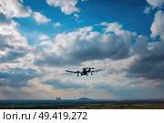 An airplane soaring in a cloudy sky, showcasing the aircraft in motion against a backdrop of billowing clouds. Стоковое AI-изображение, AI-художник Данила Большаков / Фотобанк Лори