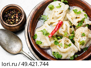 Traditional Russian dish pelmeni.Meat dumplings on rustic background. Oriental dumplings with minced meat. Стоковое фото, агентство Ingram Publishing / Фотобанк Лори
