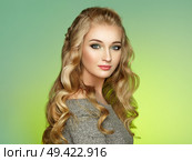 Blonde Girl with Long and Shiny Curly Hair. Beautiful Model Woman with Curly Hairstyle. Care and Beauty Hair Products. Lady with braided hair. Стоковое фото, агентство Ingram Publishing / Фотобанк Лори