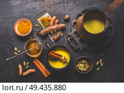 Healthy ingredients of turmeric milk drink with fresh turmeric roots , spices and honey. Hot winter beverage. Immune boosting remedy , detox and dieting concept. Стоковое фото, агентство Ingram Publishing / Фотобанк Лори