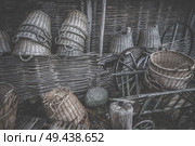 Weave baskets workshop stacked in a wooden cabin with old wheels and ladders. Стоковое фото, агентство Ingram Publishing / Фотобанк Лори