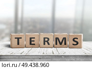 Terms sign in a bright office on a wooden desk with windows in the background. Стоковое фото, агентство Ingram Publishing / Фотобанк Лори