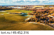 Spring rural aerial landscape. Spring melting snow on march agricultural fields. Minsk city on background. winter crops and plowed field. Belarus . Стоковое фото, агентство Ingram Publishing / Фотобанк Лори