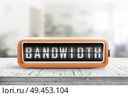 Bandwidth alarm message on a retro device in orange color in a bright room. Стоковое фото, агентство Ingram Publishing / Фотобанк Лори