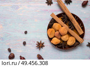 blue wooden background with cinnamon, anise, dog rose  and dried apricots. Стоковое фото, агентство Ingram Publishing / Фотобанк Лори