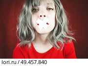Young woman with a cross covering her mouth                               . Стоковое фото, агентство Ingram Publishing / Фотобанк Лори