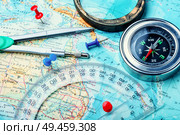 Retro compass with vintage map.Compass on map background. Compass on map. Стоковое фото, агентство Ingram Publishing / Фотобанк Лори