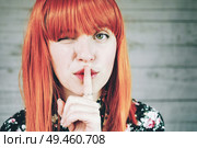 Young redhead woman doing a silent gesture                               . Стоковое фото, агентство Ingram Publishing / Фотобанк Лори