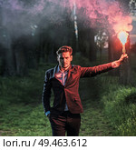 Conceptual portrait of an ambitious businessman holding a red flare. Стоковое фото, агентство Ingram Publishing / Фотобанк Лори