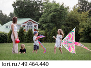 A family with three children. A mother with many children and toddlers in a summer park. Children are walking and flying a kite. Large families, family values, and leisure time with children. Стоковое фото, фотограф Photojuli / Фотобанк Лори