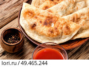 Cheburek, unleavened patty stuffed with minced meat.Traditional Tatar pastry. Cheburek,dough pie with meat filling. Стоковое фото, агентство Ingram Publishing / Фотобанк Лори