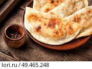 Cheburek, unleavened patty stuffed with minced meat.Cheburek, the national dish of the Crimean Tatars. Cheburek,dough pie with meat filling. Стоковое фото, агентство Ingram Publishing / Фотобанк Лори