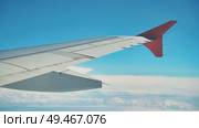 Airplane wing flying above the clouds on a beautiful sunny day. Стоковое фото, фотограф Mikhail Davidovich / Фотобанк Лори