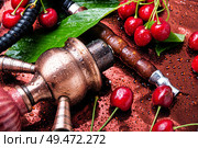 Tobacco pipe and smoking tobacco with rose flavor.Refined taste of tobacco. Smoking rose-flavored tobacco. Стоковое фото, агентство Ingram Publishing / Фотобанк Лори