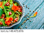 Healthy salad with flowers, nasturtium leaves, tomatoes and nuts. Summer food.Indian salad.Capuchin. Salad with vegetables and nasturtium. Стоковое фото, агентство Ingram Publishing / Фотобанк Лори