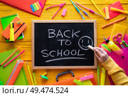 Back to school supplies arrangement vivid colorful neon color and blackboard hand chalk. Стоковое фото, агентство Ingram Publishing / Фотобанк Лори