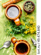Cup with medicinal tea from Hypericum.Herbal medicine. Tea with Hypericum flowers. Стоковое фото, агентство Ingram Publishing / Фотобанк Лори