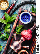 Smoking hookah with mint flavor.Shisha mint tobacco.Shisha hookah with spearmint. East hookah with spearmint. Стоковое фото, агентство Ingram Publishing / Фотобанк Лори