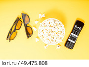 bowl of popcorn, nd remote control for TV and 3d glasses over yellow background, movie and cinema concept. popcorn and 3d glasses. Стоковое фото, агентство Ingram Publishing / Фотобанк Лори