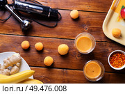 blender  laying at wooden table with fresh fruit smoothie with bananas, sea buckthorn and apricots  . flat lay. Стоковое фото, агентство Ingram Publishing / Фотобанк Лори