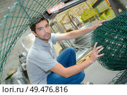 a male worker with fencing roll. Стоковое фото, агентство Ingram Publishing / Фотобанк Лори