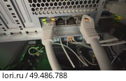 A mesmerizing close-up of blinking server lights and tangled network cables, capturing the pulse of modern technology. Стоковое видео, видеограф Виктор Ветошкин / Фотобанк Лори