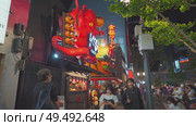 Osaka, Japan - Sep 21 2024, 4k, Panoramic view of Dotonbori street with various cafes, restaurants, bright signs and advertisements, illumination, a lot of people walking, at night, Osaka, Japan. Редакционное видео, видеограф Сергей Богомяко / Фотобанк Лори