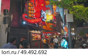 Osaka, Japan - Sep 21 2024, 4k, Panoramic view of Dotonbori street with various cafes, restaurants, bright signs and advertisements, illumination, a lot of people walking, at night, Osaka, Japan. Редакционное видео, видеограф Сергей Богомяко / Фотобанк Лори